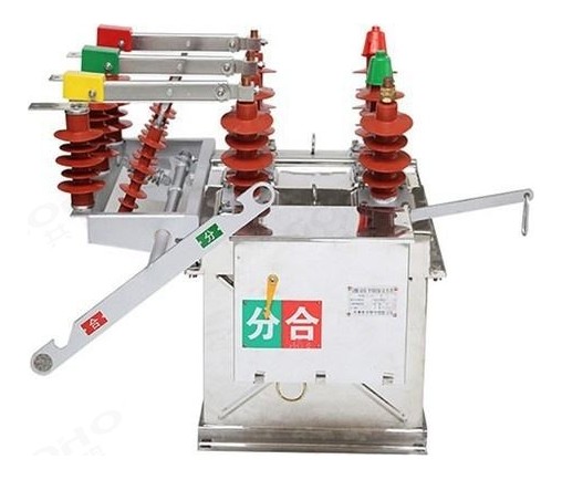 ZW8-12 outdoor vacuum circuit breaker with the manual operating handle engaged, showing the spring mechanism, the coloured phase insulators and the open/close indicator flag.